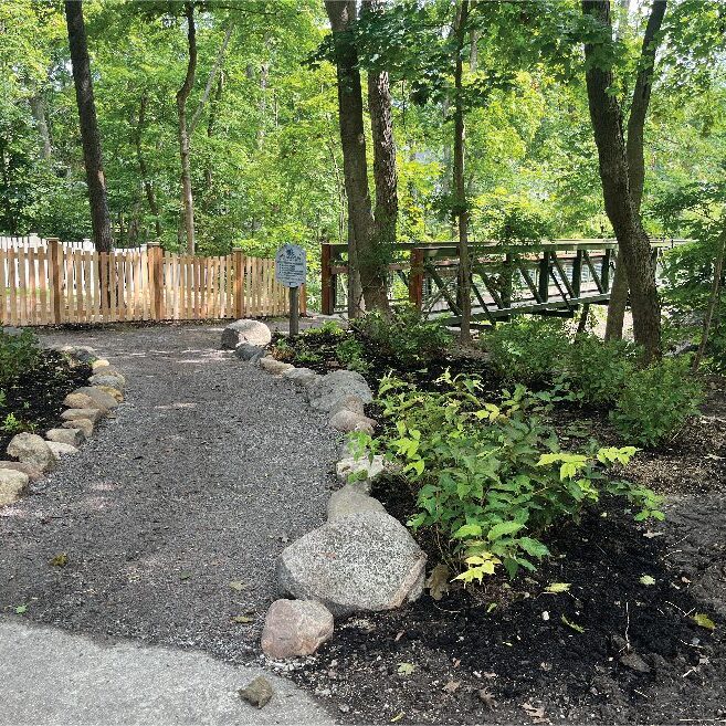 Naturalized pathways constructed of decomposed granite and mixed size boulders.
